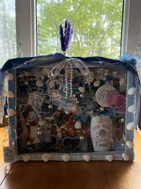 A shadow-box Memory Box with wedding photos, shells, and keepsakes from a beach wedding
